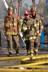 Yellow hoses lie about as tons of water flow within them to douse the flames in Belmont Shore. (83kb)