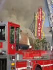 The heavily-papered teacher supply/toy store is separated only by a brick wall from the burning building. (63kb)